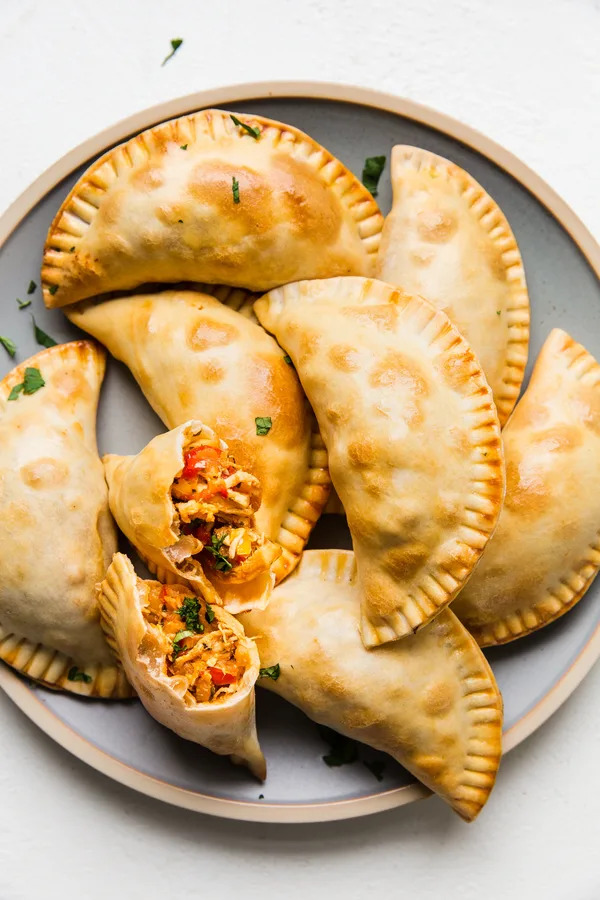 8 homemade chicken empanadas on a plate