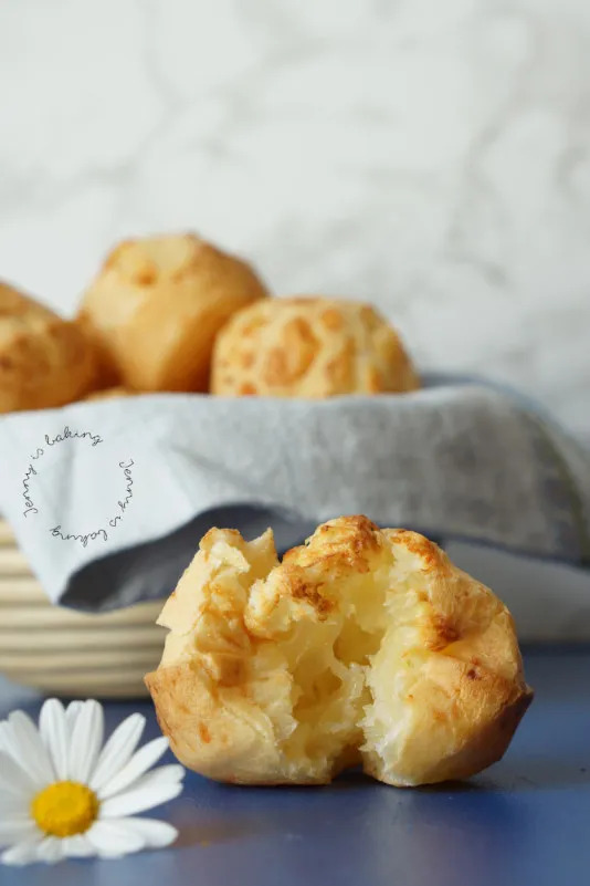 Paraguayan chipas, one torn open to show the soft inside